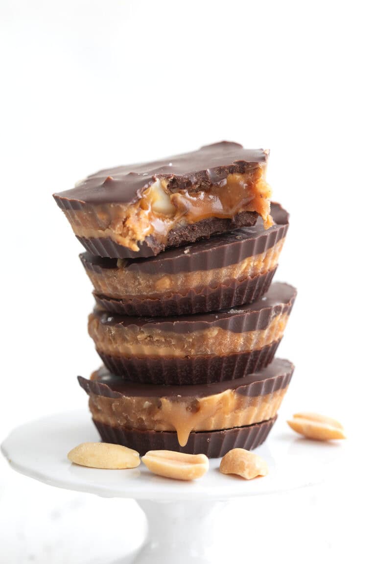 A stack of Keto Snickers Cups with a bite taken out of the top one.