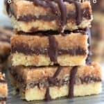 Titled Pinterest image of a stack of Keto Samoa Cookie Bars on a metal tray, close up.