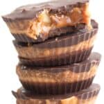 Titled image of a stack of Keto Snickers Cups on a white cupcake stand.