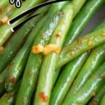 Close up titled image of keto green beans with chili and garlic in a pan.