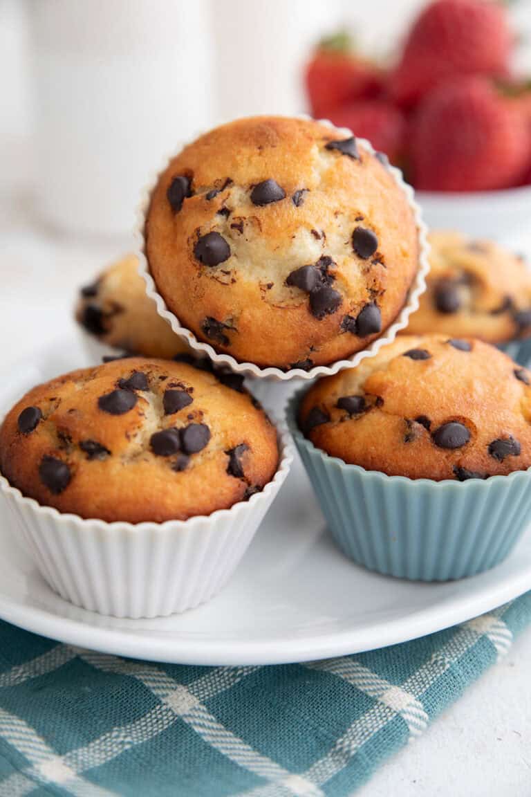 Egg Free Muffins in silicone liners piled up on a white platter.