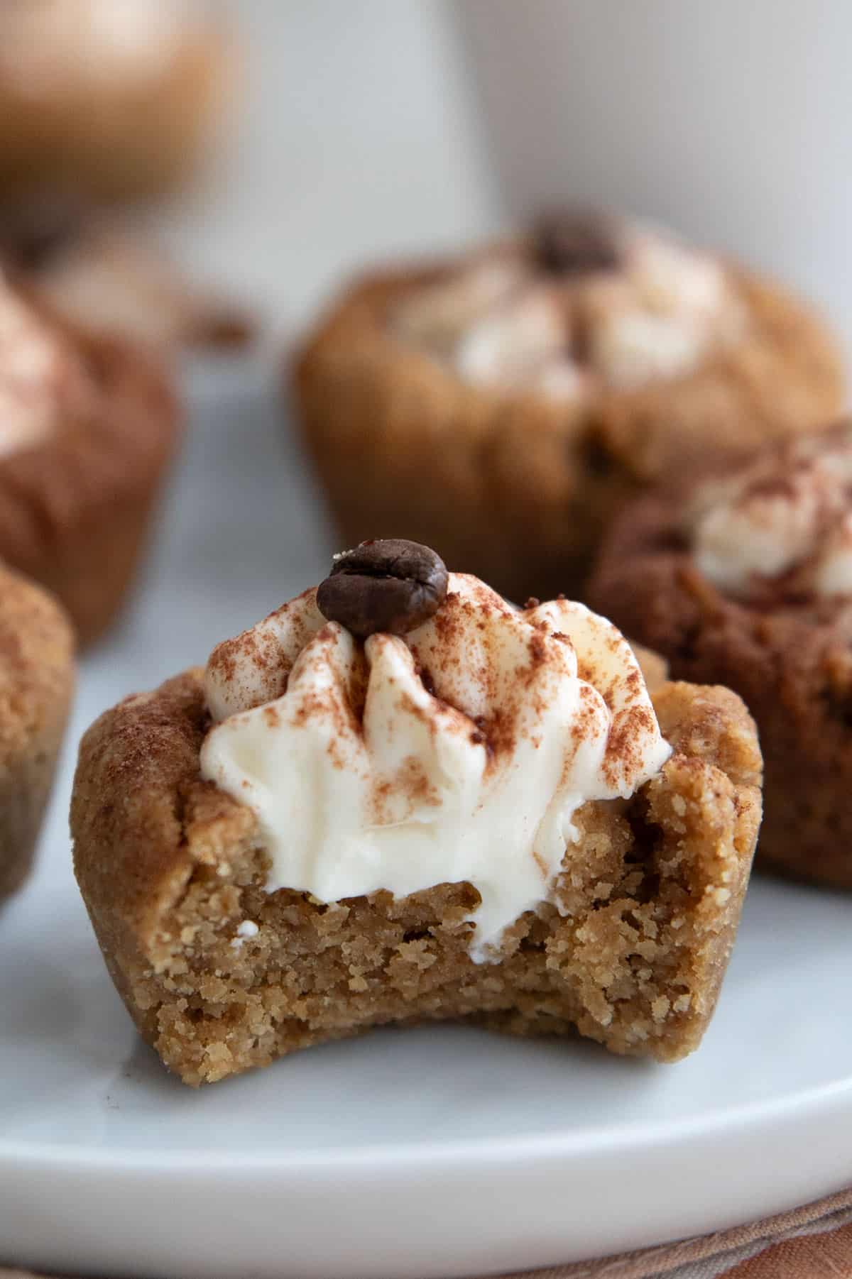 Close up shot of a Keto Tiramisu Cookie Cup with a bite taken out of it.