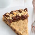 Titled image of a slice of Keto Peanut Butter Cookie Cake on a white plate.