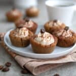 Five Keto Tiramisu Cookie Cups on a small white dessert plate over a beige napkin.