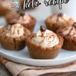 Titled image of Keto Tiramisu Cookie Cups on a small white plate over a beige napkin.