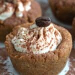 Close up shot of a Keto Tiramisu Cookie Cup on a white plate with cocoa powder sprinkled all over.