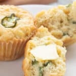 Close up shot of Keto Jalapeno Cheddar Muffins with a pat of butter melting on top.