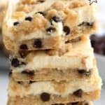 Titled image of a stack of Keto Chocolate Chip Cookie Cheesecake Bars with a bite taken out of the top one.