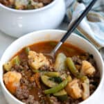 Keto minestrone style soup with cauliflower and ground beef in a white bowl.