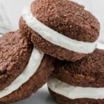Titled image of Keto Gingerbread Whoopie Pies piled up on a white plate.