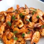 Titled image of Easy Chili Garlic Shrimp in a white bowl with chopped parsley sprinkled overtop.