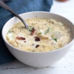 Close up shot of a white bowl filled with keto seafood chowder.