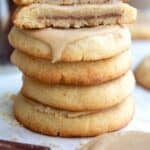Titled image of a stack of Keto Pop Tart Cookies with the top one cut in half to show the cinnamon brown sugar filling.