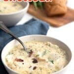Titled image of a bowl of keto seafood chowder on a white table with a blue napkin.