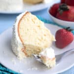 A slice of Keto Coconut Cake with a forkful taken out of it.