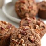 Titled image of Keto Brown Butter Pecan Muffins on a marble tabletop with a cup of coffee.