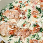 Close up shot of Creamy Spinach Feta Chicken in a white skillet.