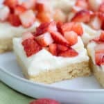 Close up shot of Keto Strawberry Shortcake Bars on a white plate over a green napkin.