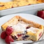 Titled image of a slice Keto Cottage Cheese Breakfast Bake on a white plate with a forkful taken out of it.