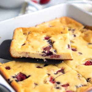 A slice of Keto Cottage Cheese Breakfast Bake on a spatula, resting on the pan.