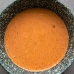 Titled image top down of Keto Comeback Sauce in a gray speckled bowl.