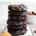 A stack of Keto No Bake Cookies with chocolate and peanut butter on a gray wooden table.