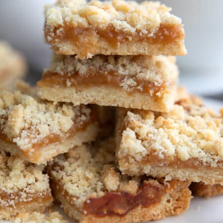 Keto Salted Caramel Butter Bars piled up on a white oval dish.