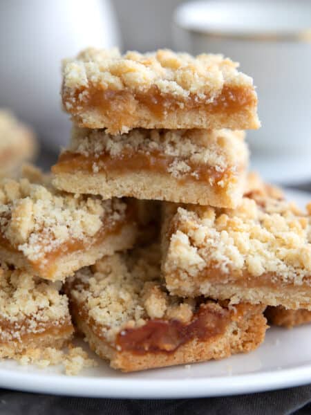 Keto Salted Caramel Butter Bars piled up on a white oval dish.