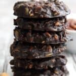 Titled image of a stack of Keto No Bake Cookies on a gray wooden table.