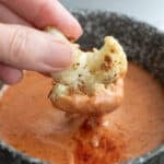 Close up shot of roasted cauliflower being dipped into keto comeback sauce.
