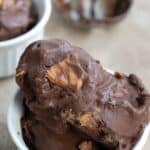 Titled image of several scoops of keto chocolate peanut butter ice cream in a white bowl.