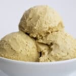 Close up shot of a white bowl with three scoops of keto pistachio ice cream.