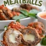 Titled image of three air fryer stuffed meatballs covered with tomato sauce on a white plate. One of the meatballs is cut in half to show the cheese inside.