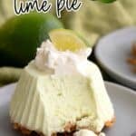 Titled image of a Keto Frozen Key Lime Pie on a small gray plate with whipped cream and a lime slice on top.